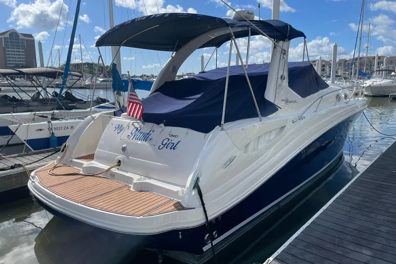 Slide: The Image of 2005 Sea Ray 340 Sundancer docked, rear view with "My Nauti Girl" nameplate. - 4