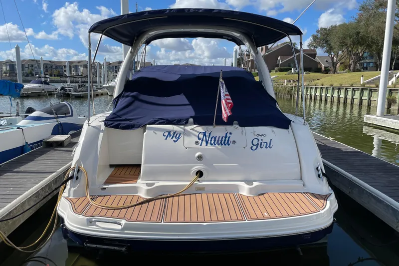 Slide: The Image of 2005 Sea Ray 340 Sundancer docked, rear view with "My Nauti Girl" nameplate. - 5