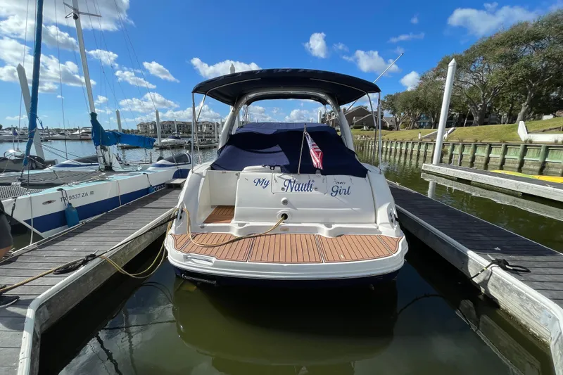 Slide: The Image of 2005 Sea Ray 340 Sundancer docked near waterfront homes under clear blue sky. - 7