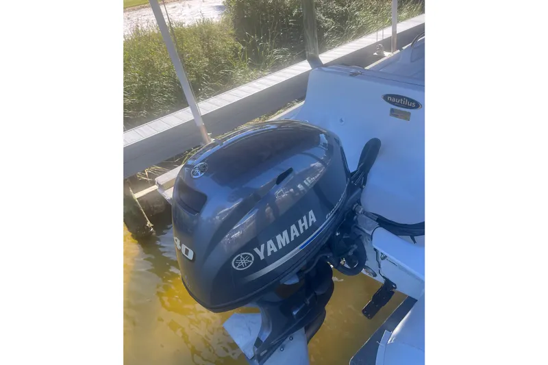 Slide: The Image of 2012 AB Inflatables Nautilus 12 DLX with Yamaha outboard motor at dock. - 4