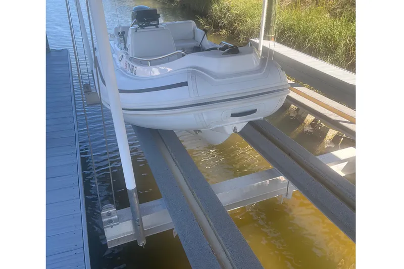 Slide: The Image of 2012 AB Inflatables Nautilus 12 DLX boat on a lift at a dock. - 6