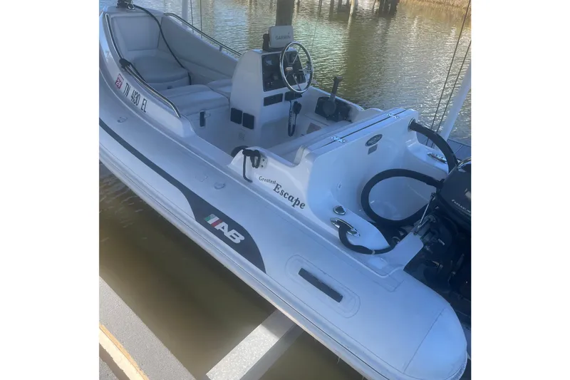 Slide: The Image of 2012 AB Inflatables Nautilus 12 DLX boat docked on water. - 9