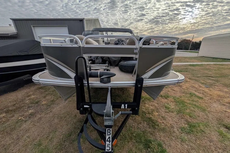 Slide: The Image of 2016 Avalon GS - 22' pontoon boat on trailer, cloudy sky background. - 3