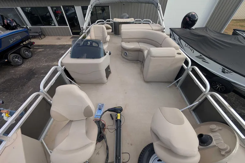 Slide: The Image of 2016 Avalon GS 22' pontoon boat interior with beige seating and helm. - 7