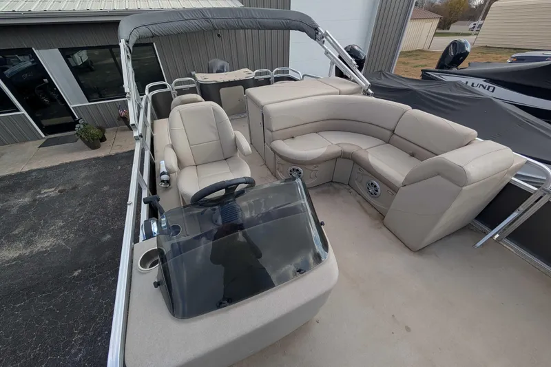 Slide: The Image of 2016 Avalon GS 22' pontoon boat with beige seating and steering console. - 8