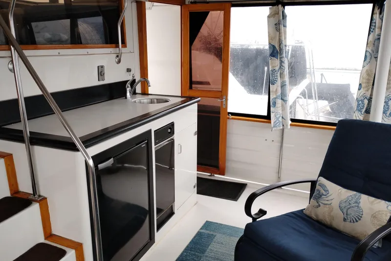 Slide: The Image of Interior of 1991 Jefferson 48 Rivanna Sundeck yacht with kitchenette and seating area. - 12