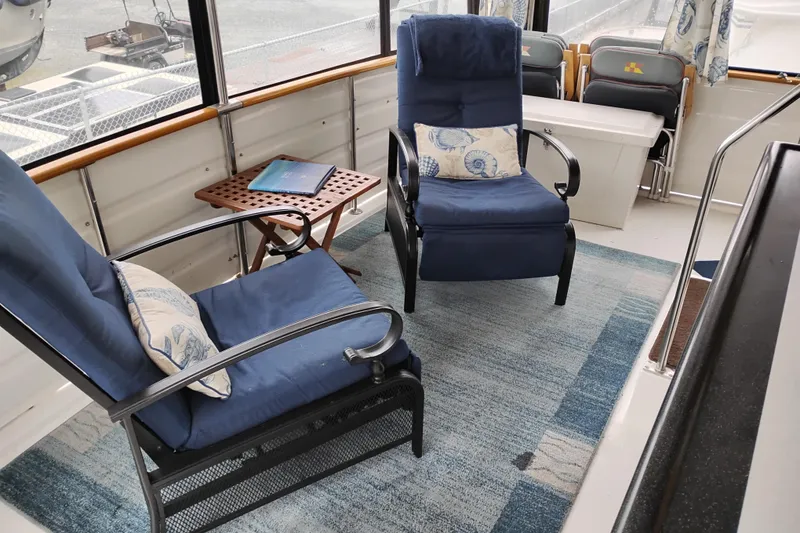 Slide: The Image of Interior of 1991 Jefferson 48 Rivanna Sundeck with blue chairs and nautical decor. - 14