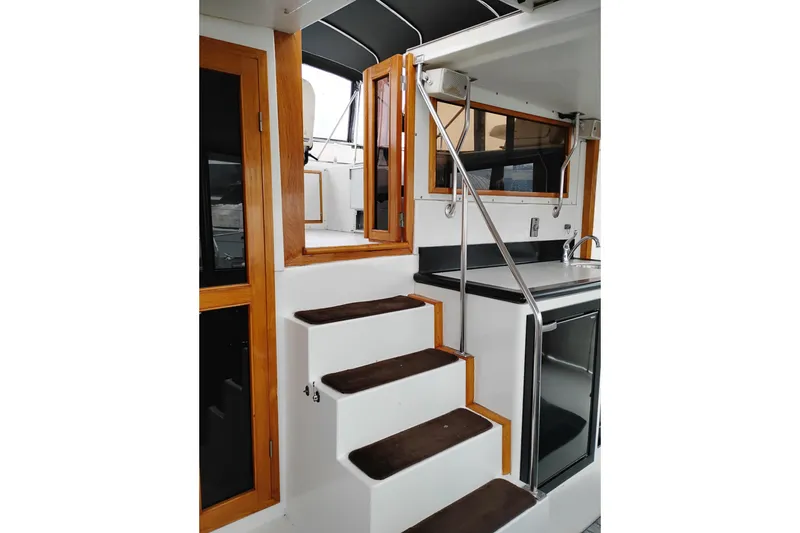Slide: The Image of Interior view of 1991 Jefferson 48 Rivanna Sundeck yacht with stairs and kitchenette. - 15