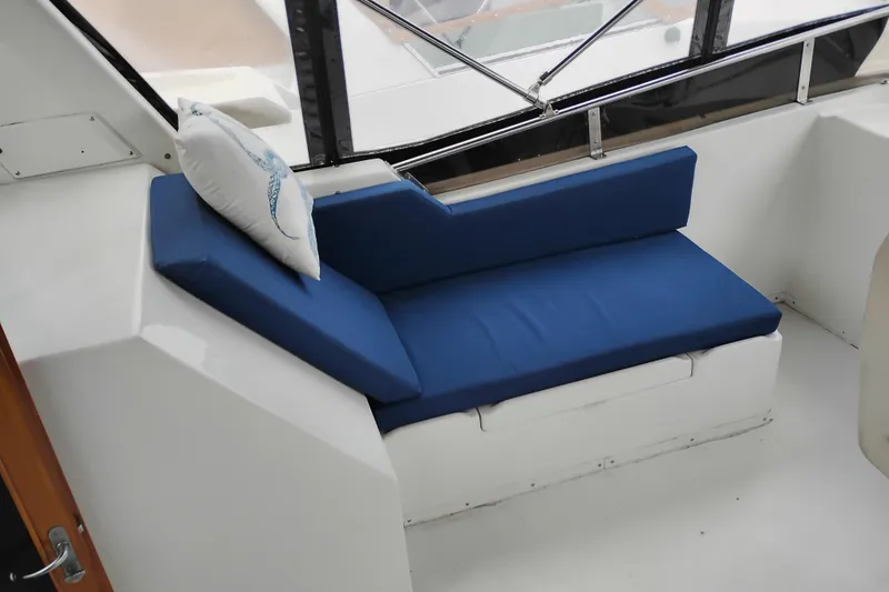 Slide: The Image of Blue cushioned seating on 1991 Jefferson 48 Rivanna Sundeck boat with decorative pillow. - 23
