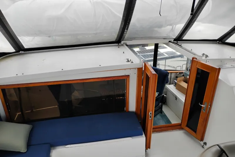 Slide: The Image of 1991 Jefferson 48 Rivanna Sundeck interior with blue seating and wooden doors. - 24