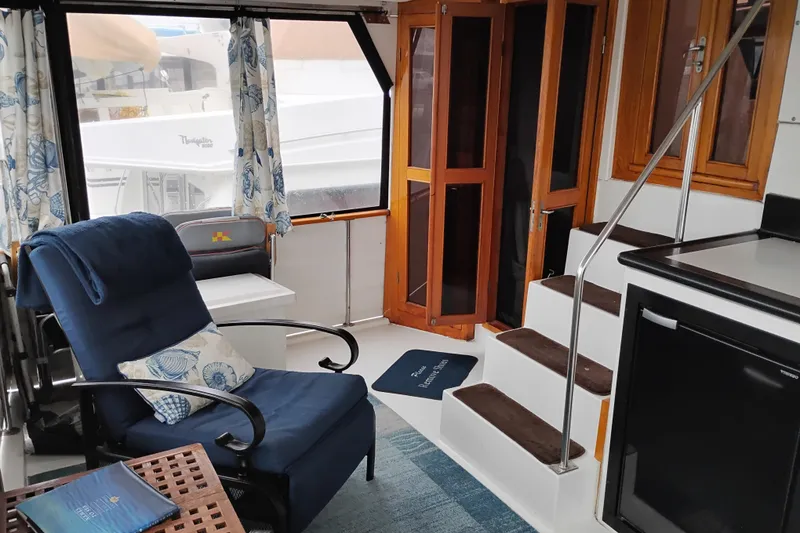 Slide: The Image of Interior of 1991 Jefferson 48 Rivanna Sundeck yacht with cozy seating and wooden accents. - 26