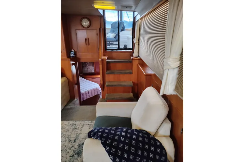 Slide: The Image of Interior of 1991 Jefferson 48 Rivanna Sundeck yacht with cozy seating and wooden accents. - 29
