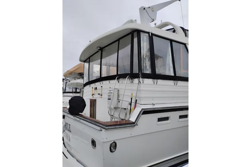 Slide: The Image of 1991 Jefferson 48 Rivanna Sundeck yacht with enclosed deck and ladder. - 3