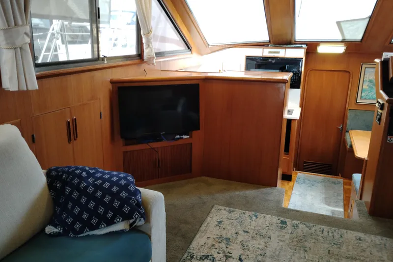 Slide: The Image of Interior of 1991 Jefferson 48 Rivanna Sundeck yacht with cozy seating and TV. - 32