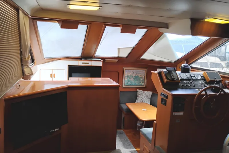 Slide: The Image of Interior of 1991 Jefferson 48 Rivanna Sundeck yacht with helm, seating, and windows. - 33