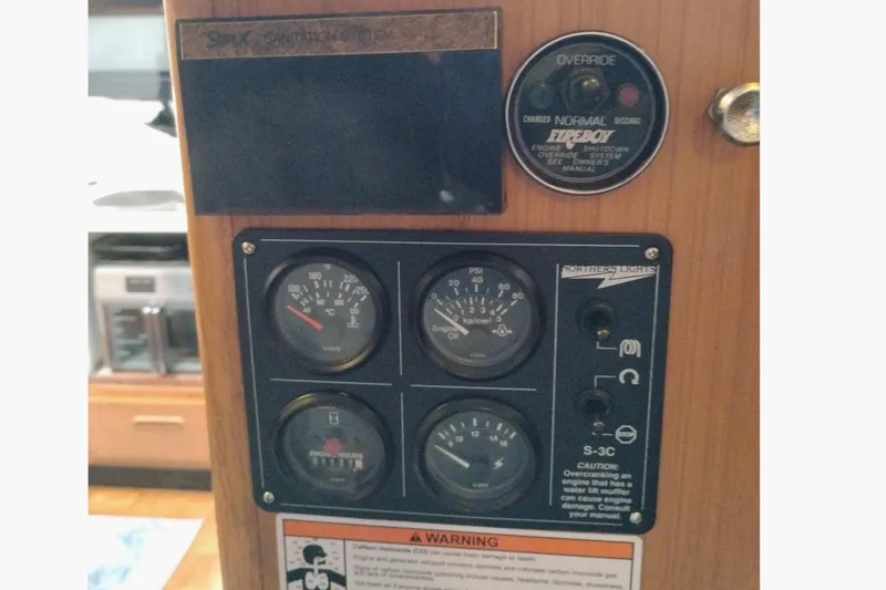 Slide: The Image of Control panel of a 1991 Jefferson 48 Rivanna Sundeck boat with gauges and warning labels. - 38