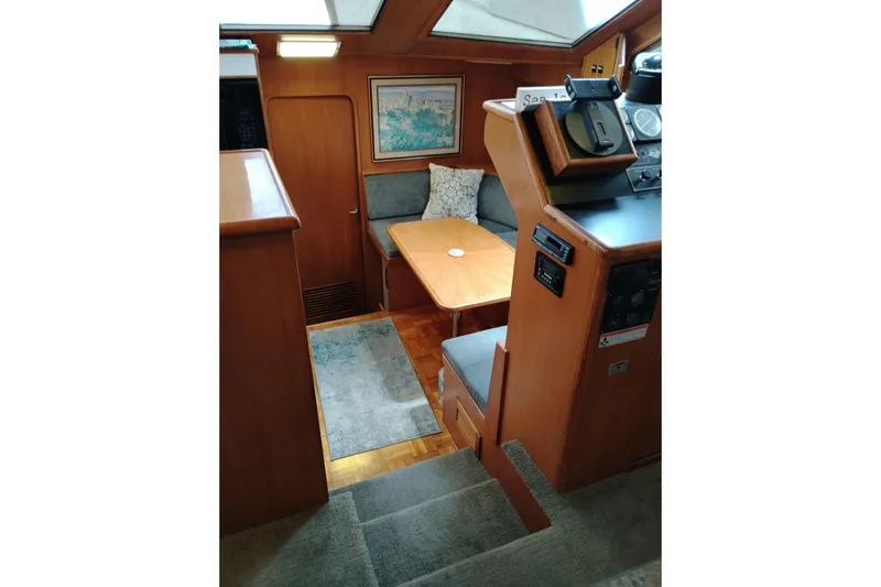 Slide: The Image of Interior of 1991 Jefferson 48 Rivanna Sundeck yacht with cozy seating and wooden finishes. - 40