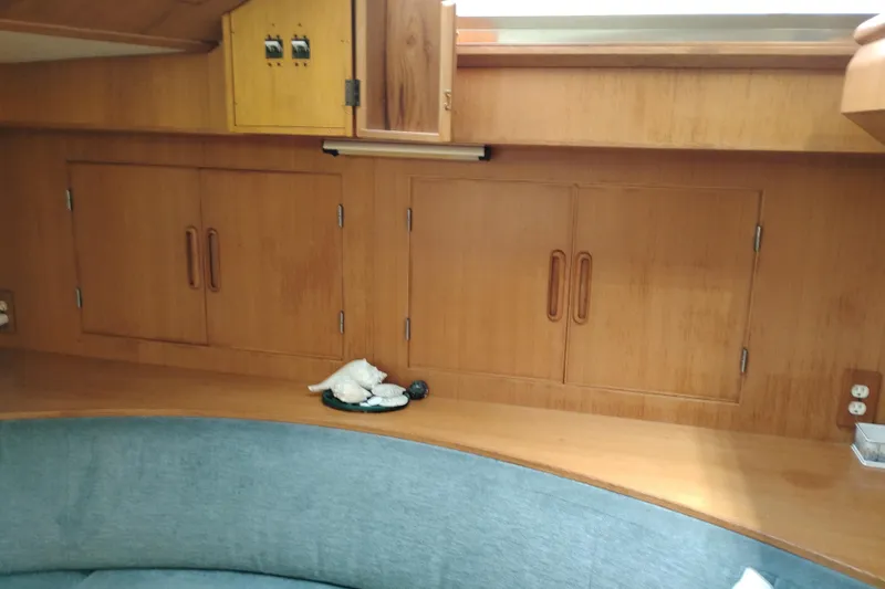Slide: The Image of Interior of 1991 Jefferson 48 Rivanna Sundeck with wooden cabinets and blue seating. - 42