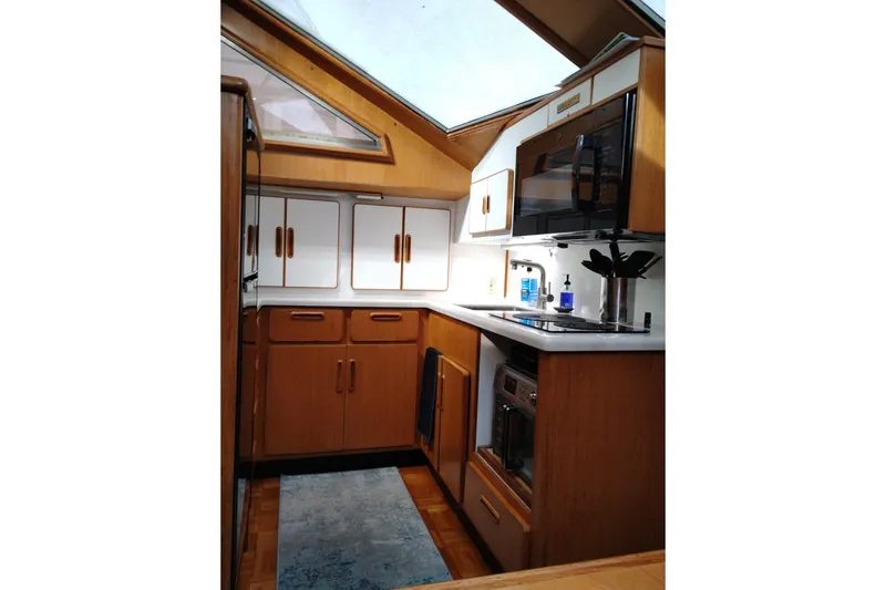 Slide: The Image of 1991 Jefferson 48 Rivanna Sundeck kitchen with wood cabinetry, skylight, and modern appliances. - 44