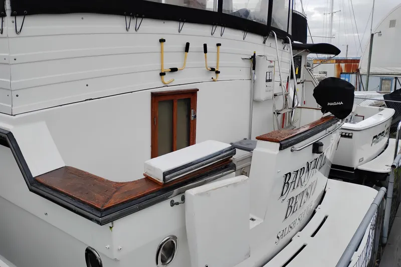 Slide: The Image of 1991 Jefferson 48 Rivanna Sundeck yacht docked, featuring a white exterior and wooden accents. - 5