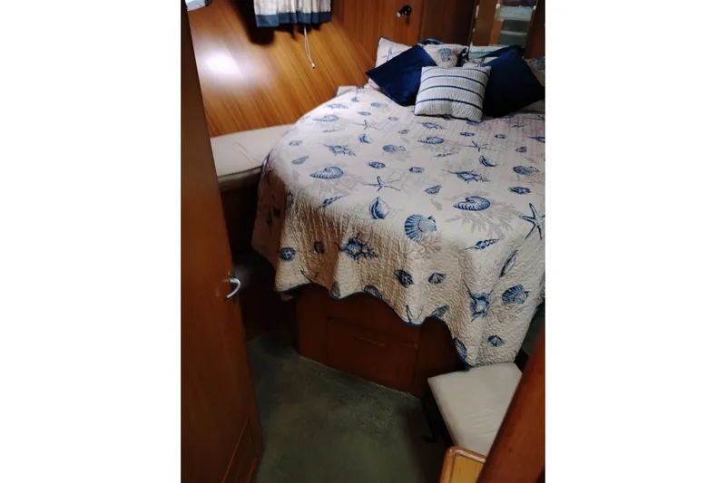 Slide: The Image of Cozy bedroom interior of 1991 Jefferson 48 Rivanna Sundeck with nautical-themed bedding. - 51