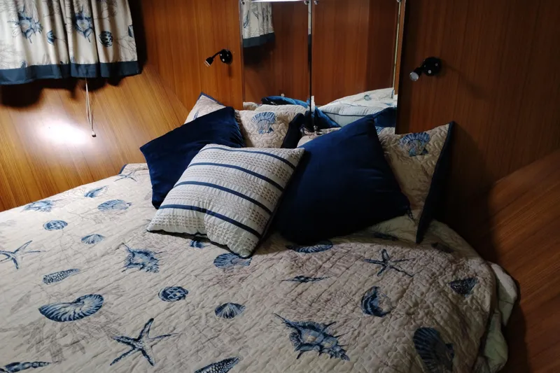 Slide: The Image of Cozy bedroom in 1991 Jefferson 48 Rivanna Sundeck with nautical-themed bedding and wooden paneling. - 52