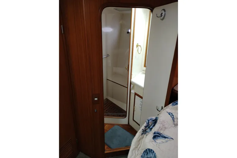 Slide: The Image of Interior of 1991 Jefferson 48 Rivanna Sundeck yacht showing bathroom with wooden door. - 53