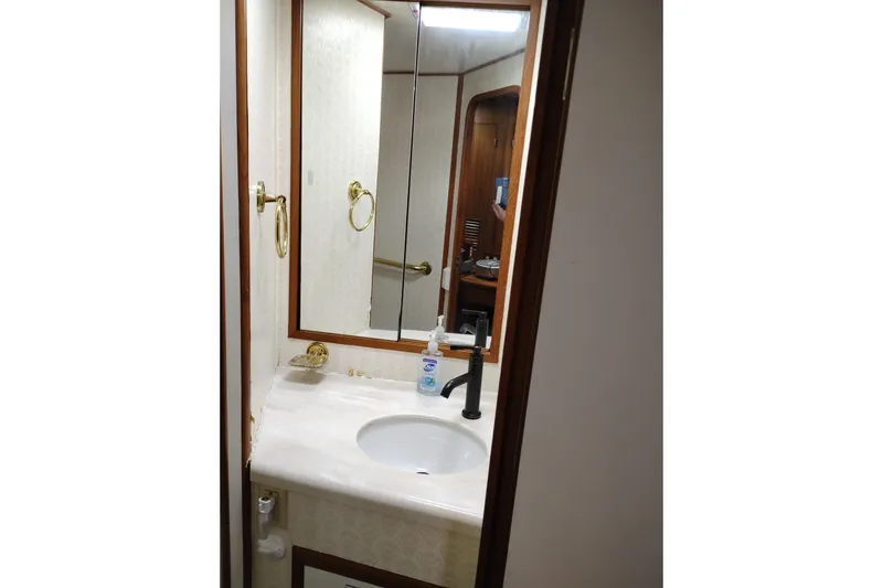 Slide: The Image of Bathroom interior of 1991 Jefferson 48 Rivanna Sundeck yacht with sink and mirror. - 54