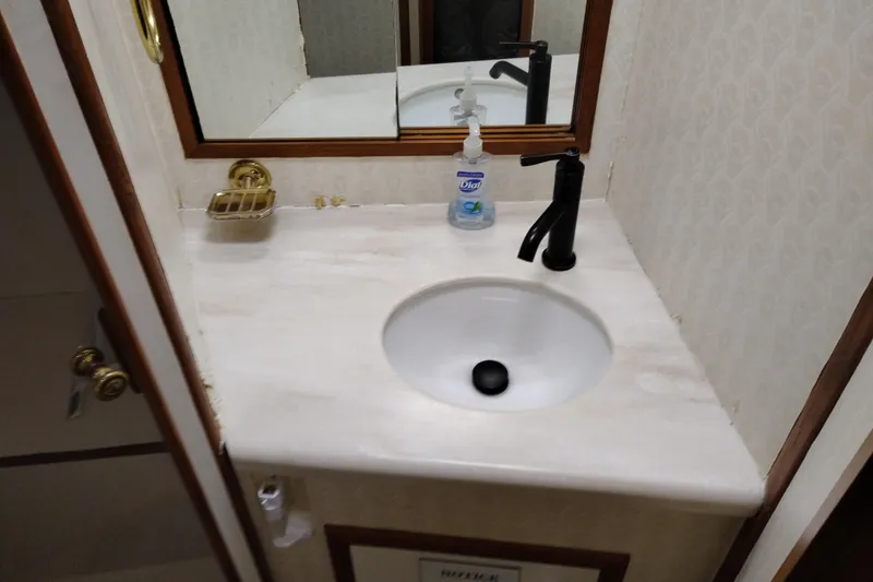 Slide: The Image of Bathroom sink area on a 1991 Jefferson 48 Rivanna Sundeck yacht. - 55
