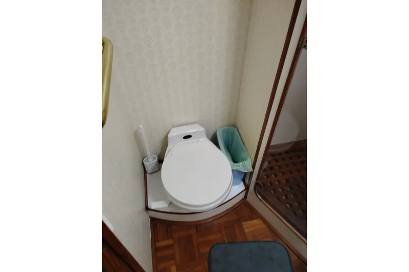 Slide: The Image of Bathroom interior of 1991 Jefferson 48 Rivanna Sundeck yacht, featuring toilet and shower. - 57