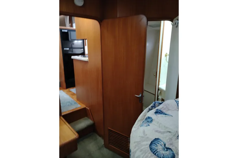 Slide: The Image of Interior of 1991 Jefferson 48 Rivanna Sundeck yacht with wooden paneling and cozy decor. - 58
