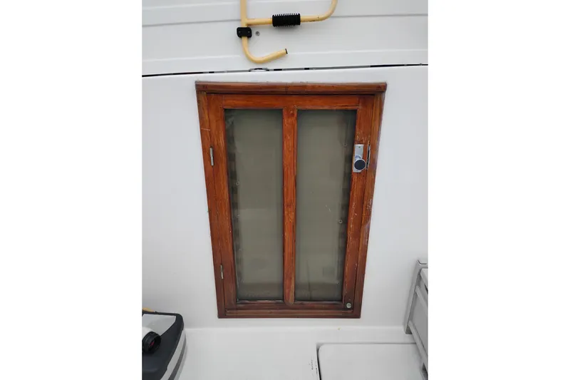Slide: The Image of Wooden-framed window on 1991 Jefferson 48 Rivanna Sundeck boat. - 6