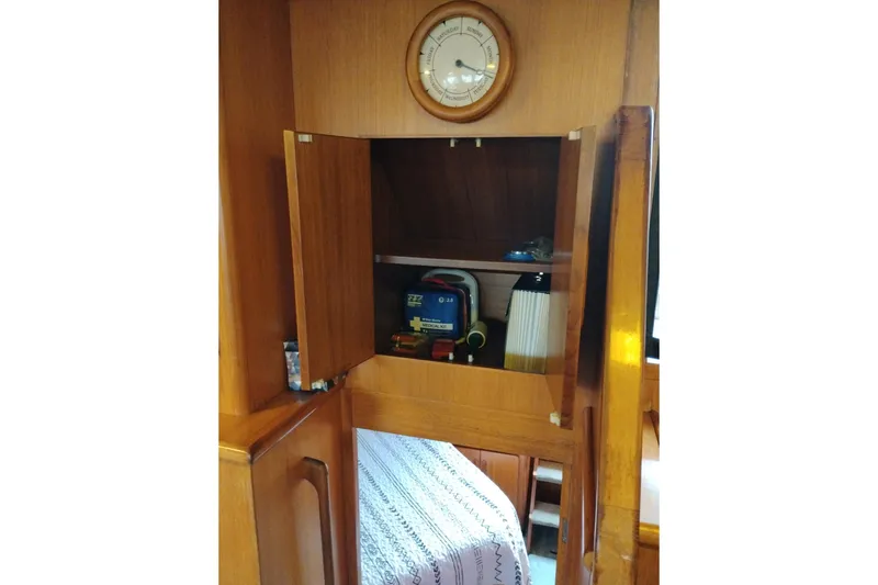 Slide: The Image of 1991 Jefferson 48 Rivanna Sundeck interior with wooden cabinet and nautical decor. - 60