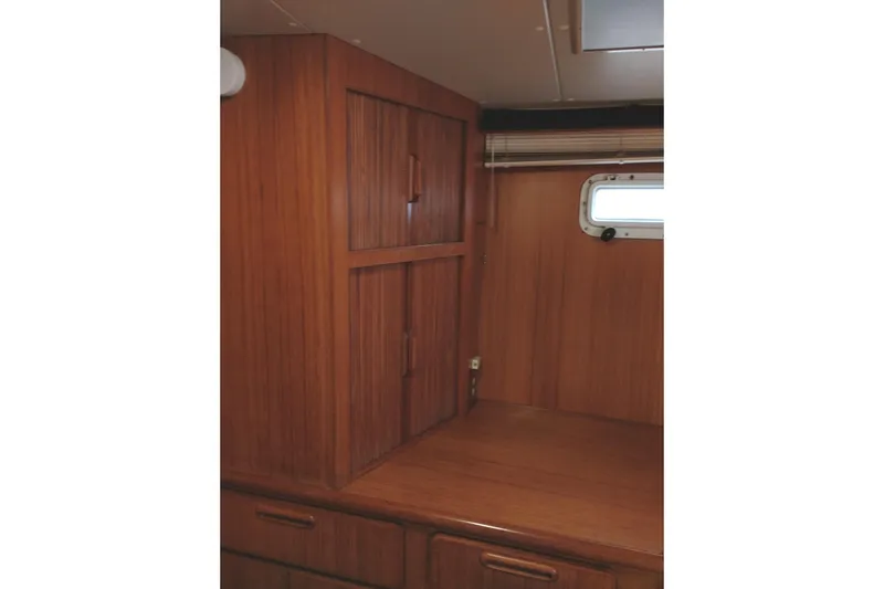 Slide: The Image of Interior of 1991 Jefferson 48 Rivanna Sundeck with wooden cabinetry and window. - 63