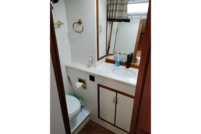 Slide: The Image of Bathroom interior of 1991 Jefferson 48 Rivanna Sundeck yacht, featuring sink and toilet. - 64