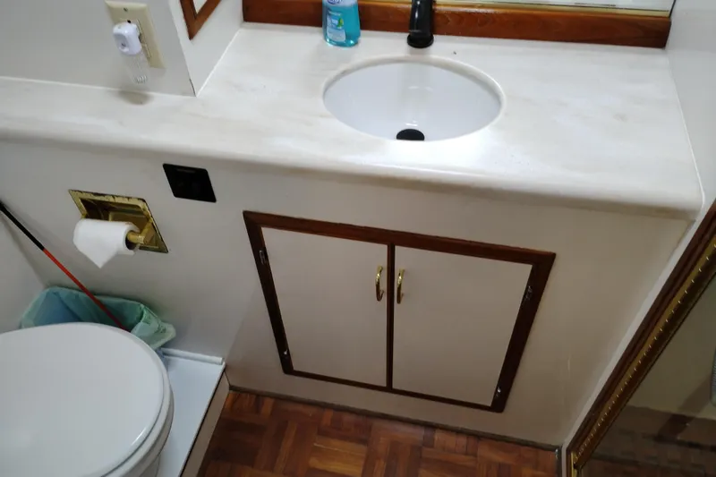Slide: The Image of Bathroom interior of 1991 Jefferson 48 Rivanna Sundeck yacht with sink and toilet. - 65