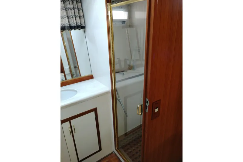Slide: The Image of Bathroom interior of 1991 Jefferson 48 Rivanna Sundeck yacht with shower and sink. - 66