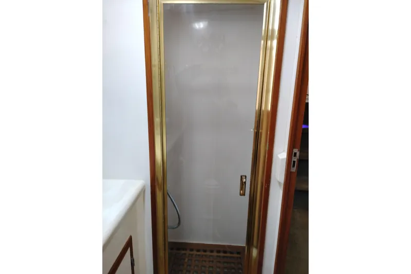 Slide: The Image of Shower area in 1991 Jefferson 48 Rivanna Sundeck yacht with gold trim. - 67