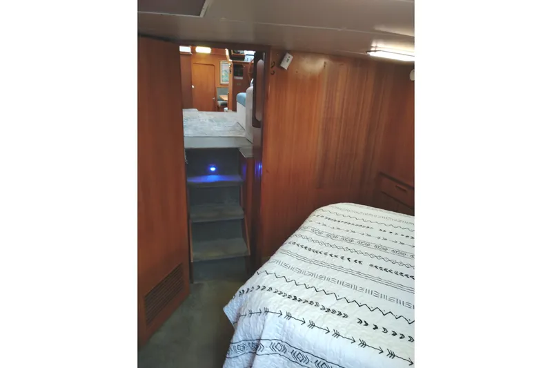 Slide: The Image of Interior of 1991 Jefferson 48 Rivanna Sundeck with wood paneling and patterned bedding. - 68