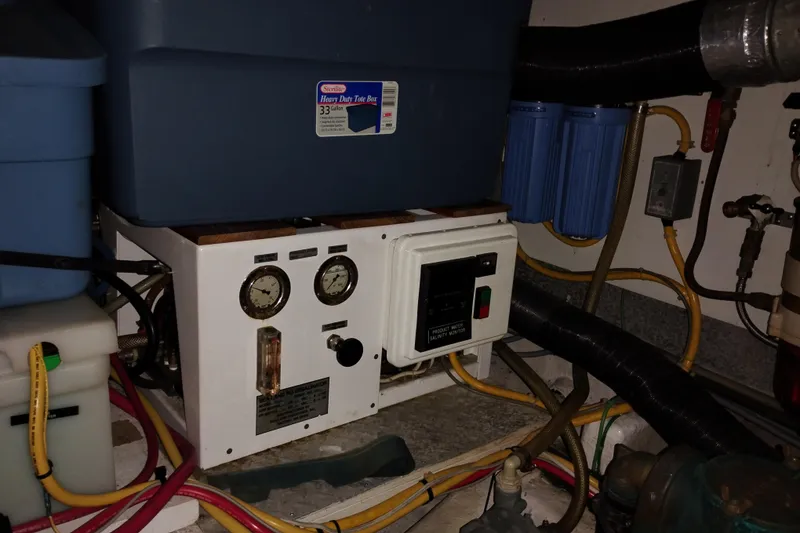 Slide: The Image of Engine room of 1991 Jefferson 48 Rivanna Sundeck with mechanical equipment and storage containers. - 72