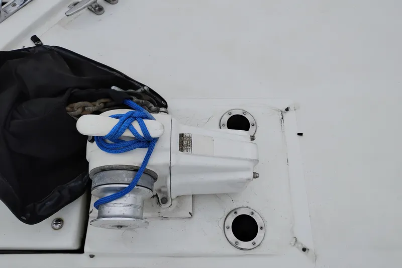 Slide: The Image of Anchor winch with blue rope on 1991 Jefferson 48 Rivanna Sundeck boat. - 82