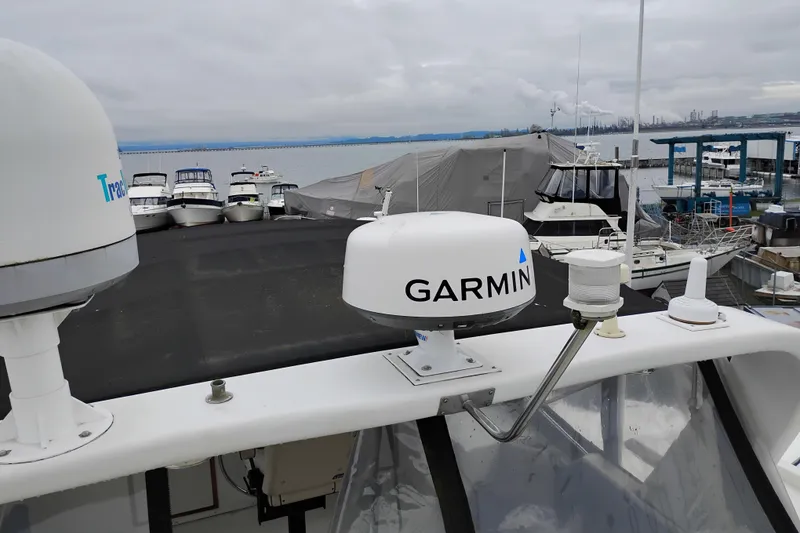 Slide: The Image of 1991 Jefferson 48 Rivanna Sundeck with Garmin radar at marina, overcast sky. - 86