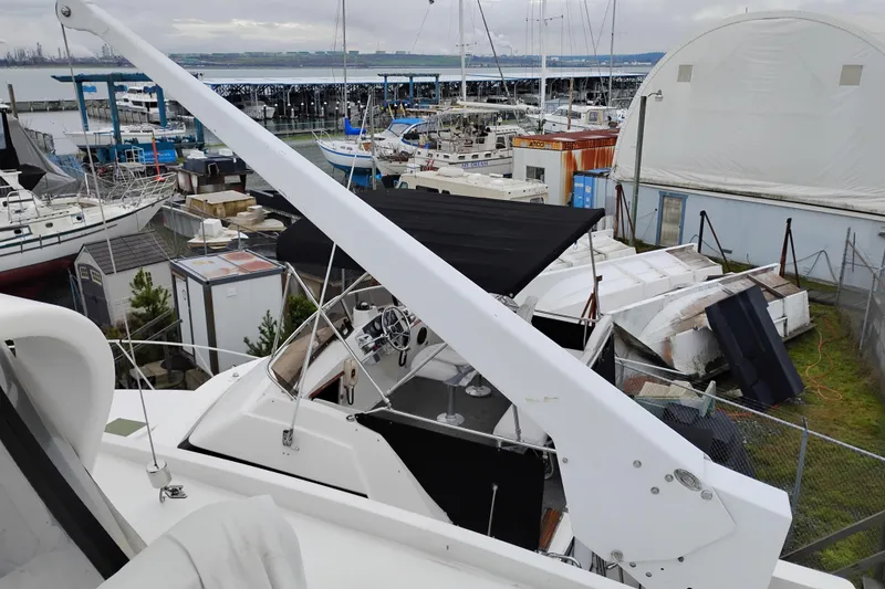 Slide: The Image of 1991 Jefferson 48 Rivanna Sundeck yacht in a marina with surrounding boats. - 88