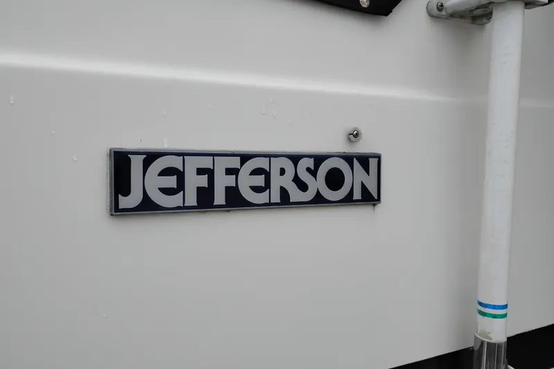 Slide: The Image of 1991 Jefferson 48 Rivanna Sundeck boat nameplate on white surface. - 91