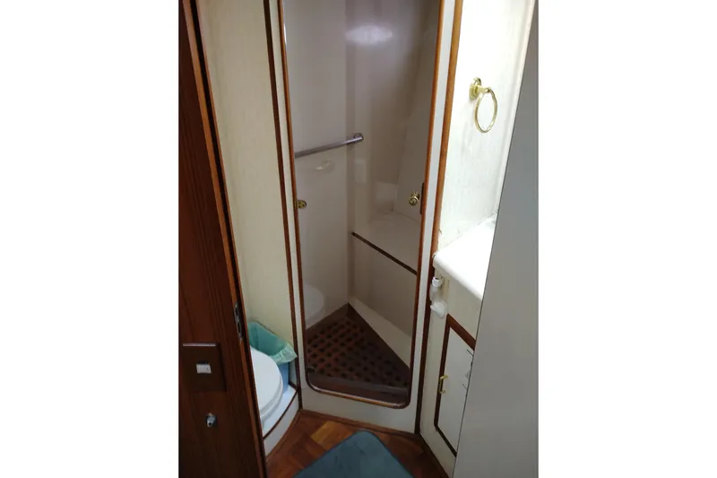 Slide: The Image of 1991 Jefferson 48 Rivanna Sundeck bathroom with shower, toilet, and wooden accents. - 56