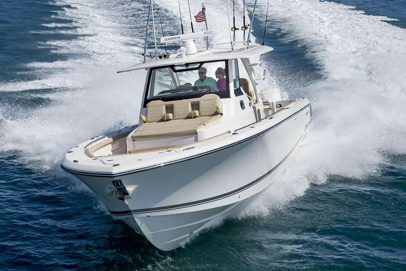 Slide: The Image of Manufacturer Provided Image: 2019 Pursuit S 408 Sport boat cruising on the ocean with passengers. - 2