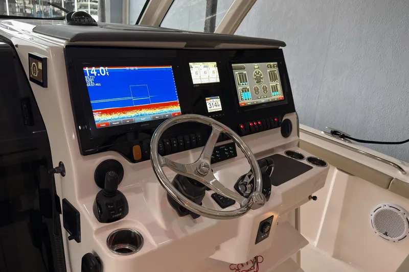 Slide: The Image of 2019 Pursuit S 408 Sport boat dashboard with advanced navigation and control systems. - 26