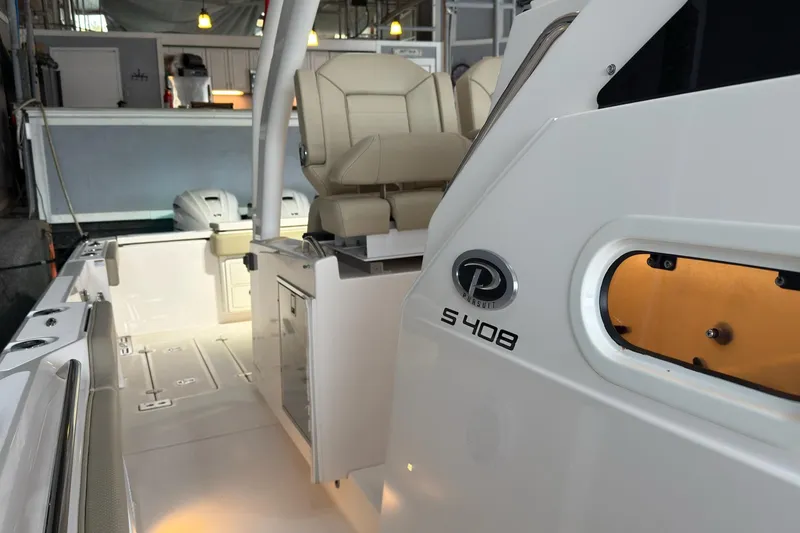 Slide: The Image of 2019 Pursuit S 408 Sport boat interior with seating and storage features. - 28