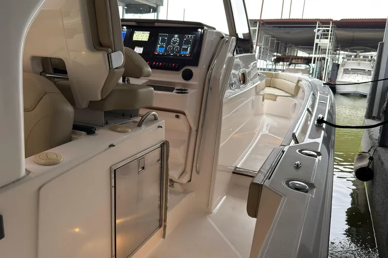 Slide: The Image of 2019 Pursuit S 408 Sport boat interior with advanced dashboard and seating. - 29