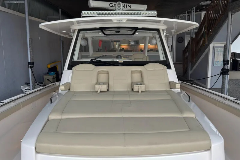 Slide: The Image of 2019 Pursuit S 408 Sport boat with beige seating in a covered dock. - 30